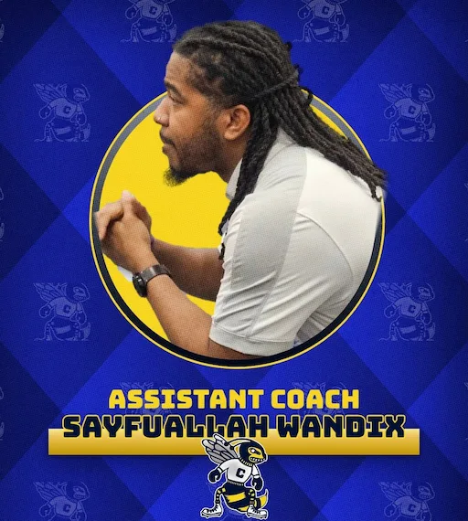 Coach Sayf working with athletes on the mat